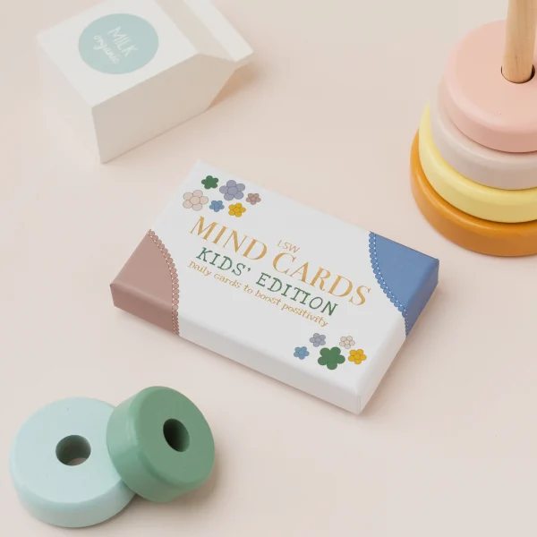 Mind Cards: Kids Edition box beside wooden stacking toys